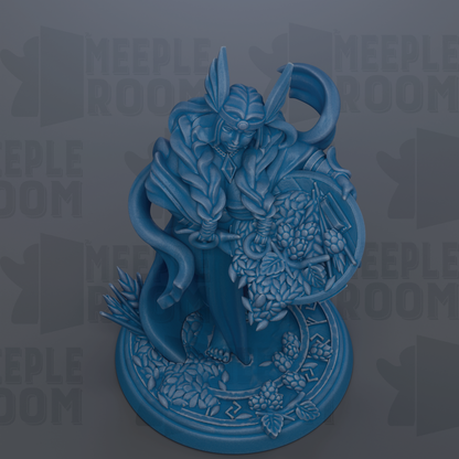 A blue figurine of a woman with a headdress, standing on a base with a circular design and various decorative elements.