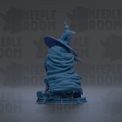 A blue statue of a wizard wearing a pointed hat, standing on a pedestal.