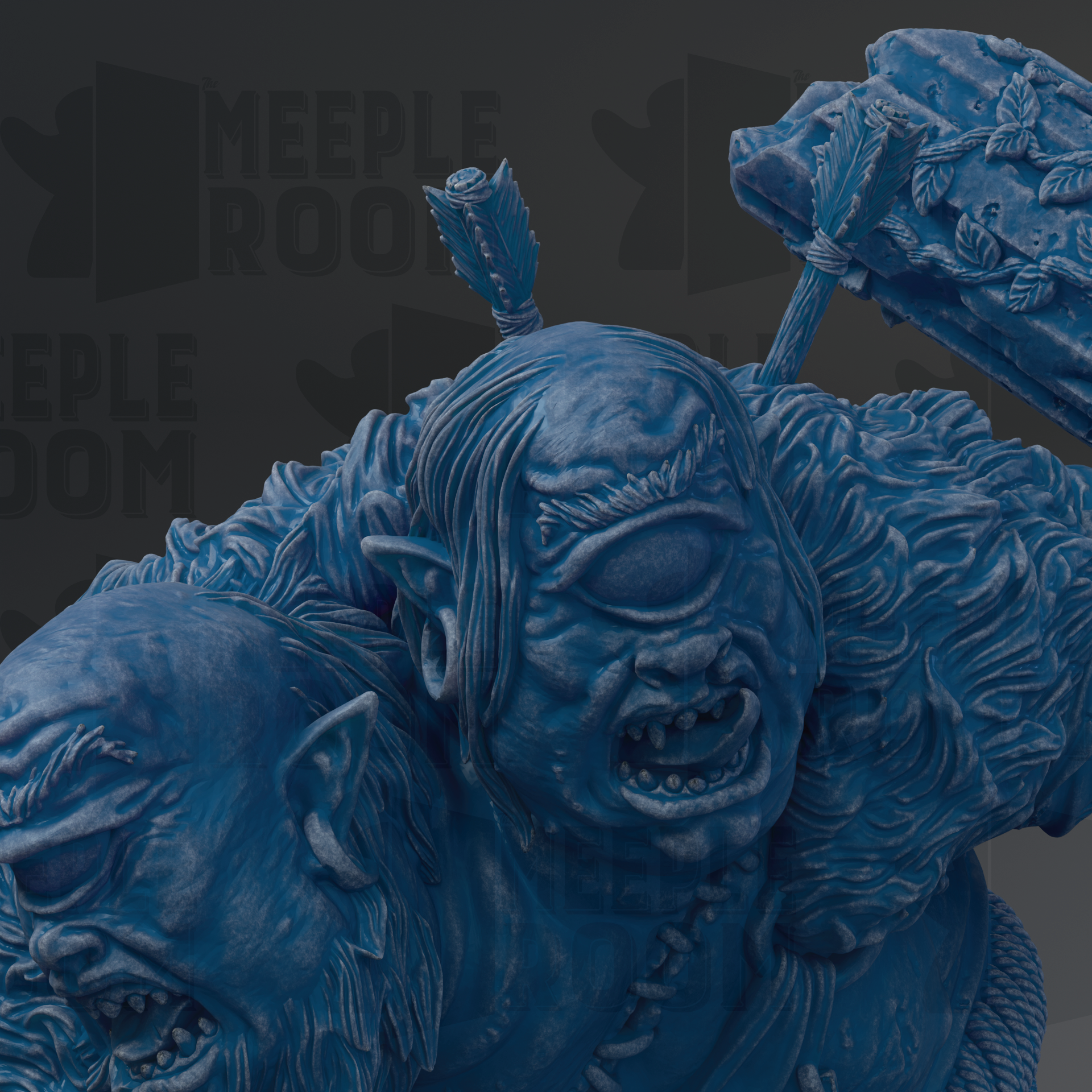 A close-up view of a blue, sculpted monster with a fierce expression, set against a dark background.
