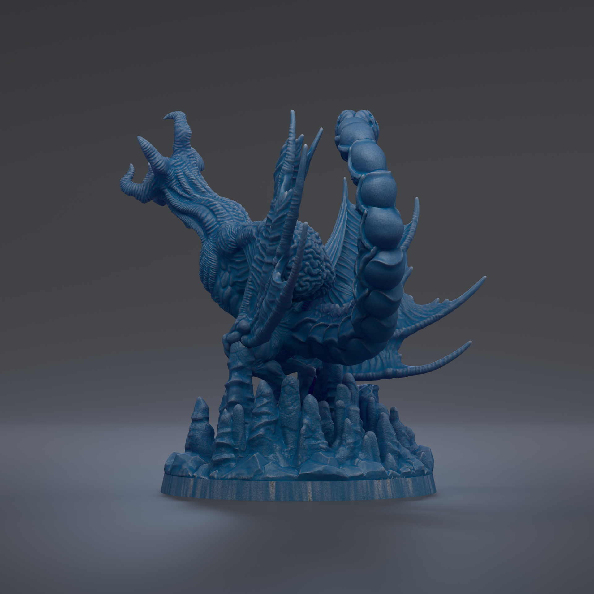 A 3D rendering of a blue dragon-like creature with sharp teeth and claws, standing on a rocky base.