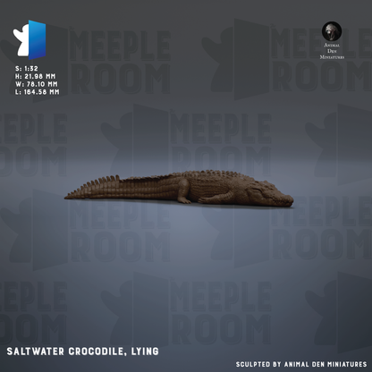 A saltwater crocodile lying on its side against a dark background.
