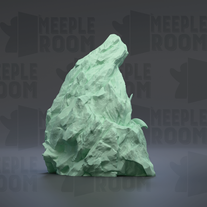 A large, jagged, green rock formation is prominently displayed against a dark background, with the repeated text "MEEPLE ROOM" visible in the background.