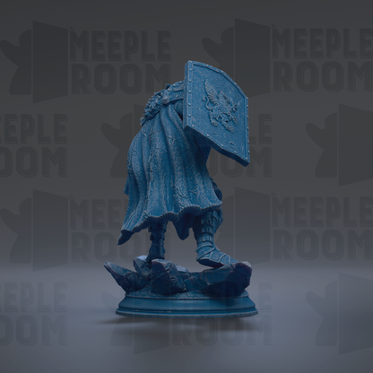 A blue statue of a person standing on a rock, wearing a shield with a lion design.