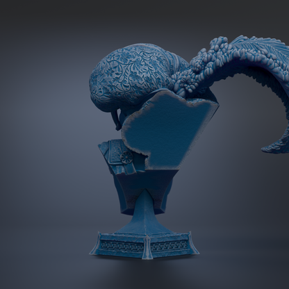 A blue, ornate sculpture of a bird perched on a pedestal.