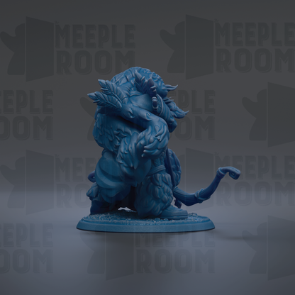 A blue figurine of a fantastical creature with horns and a long tail, sitting on a base and facing to the right.