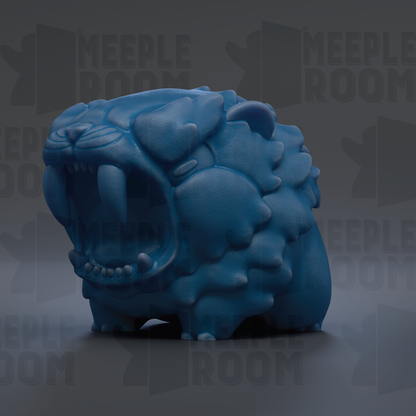 A blue, sculpted animal with sharp teeth and an open mouth, resembling a fierce-looking creature.