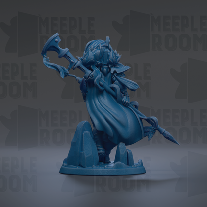 A blue figurine of a character with a long, flowing robe and a large weapon, standing on a rock formation.