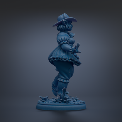 A blue statue of a woman wearing a hat and dress, standing on a base with flowers.