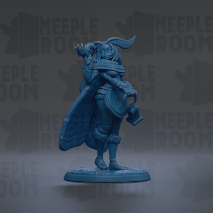 A blue figurine of a winged, winged creature with a long tail, standing on a base and holding a shield.