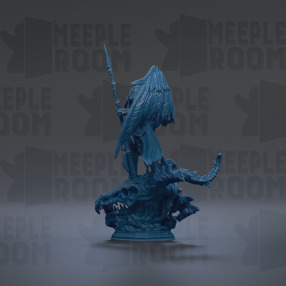 A blue figurine of a winged creature, possibly a dragon or serpent, standing on a rock formation.