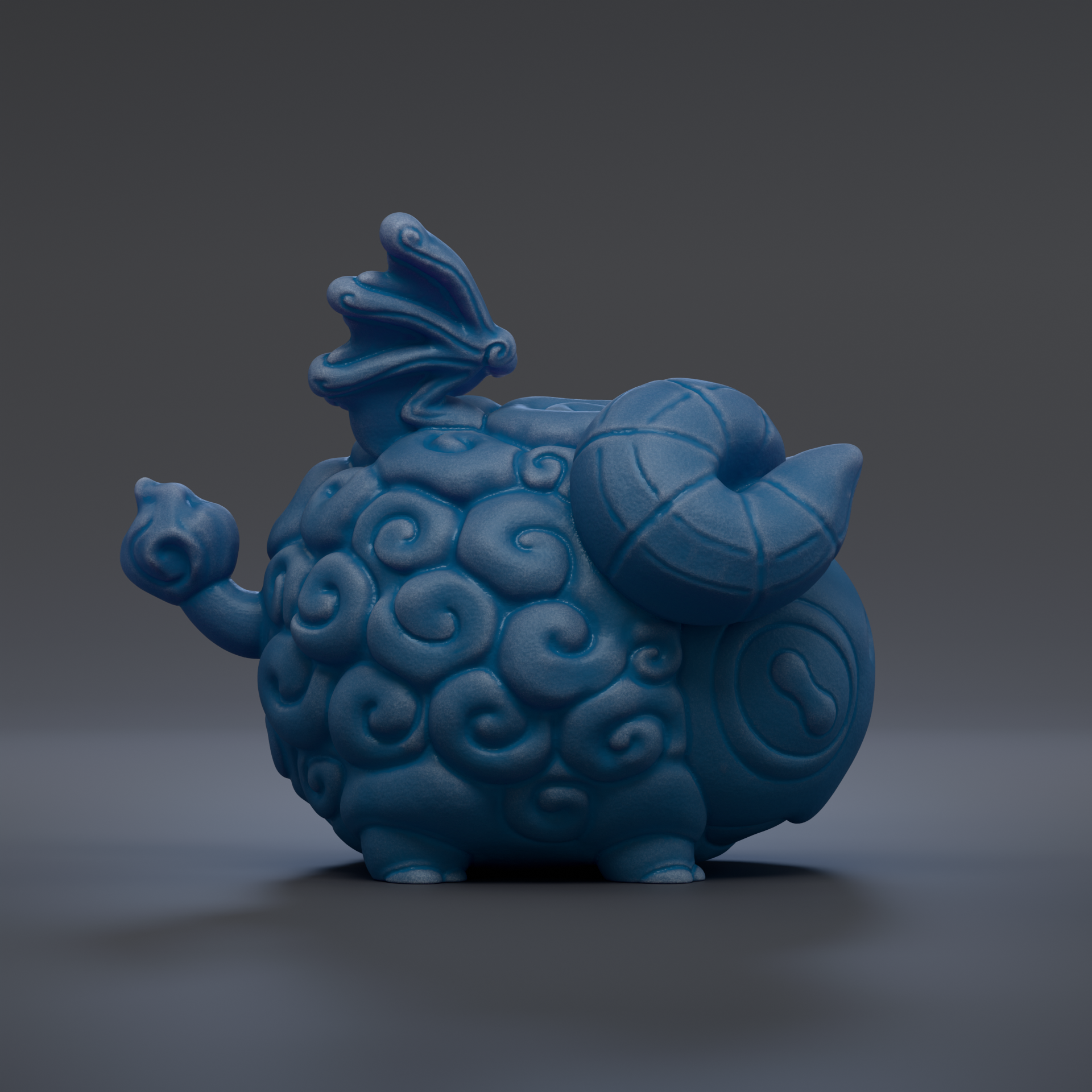 A blue, whimsical ceramic figurine with a dragon-like head and curled horns, sitting on a dark surface.