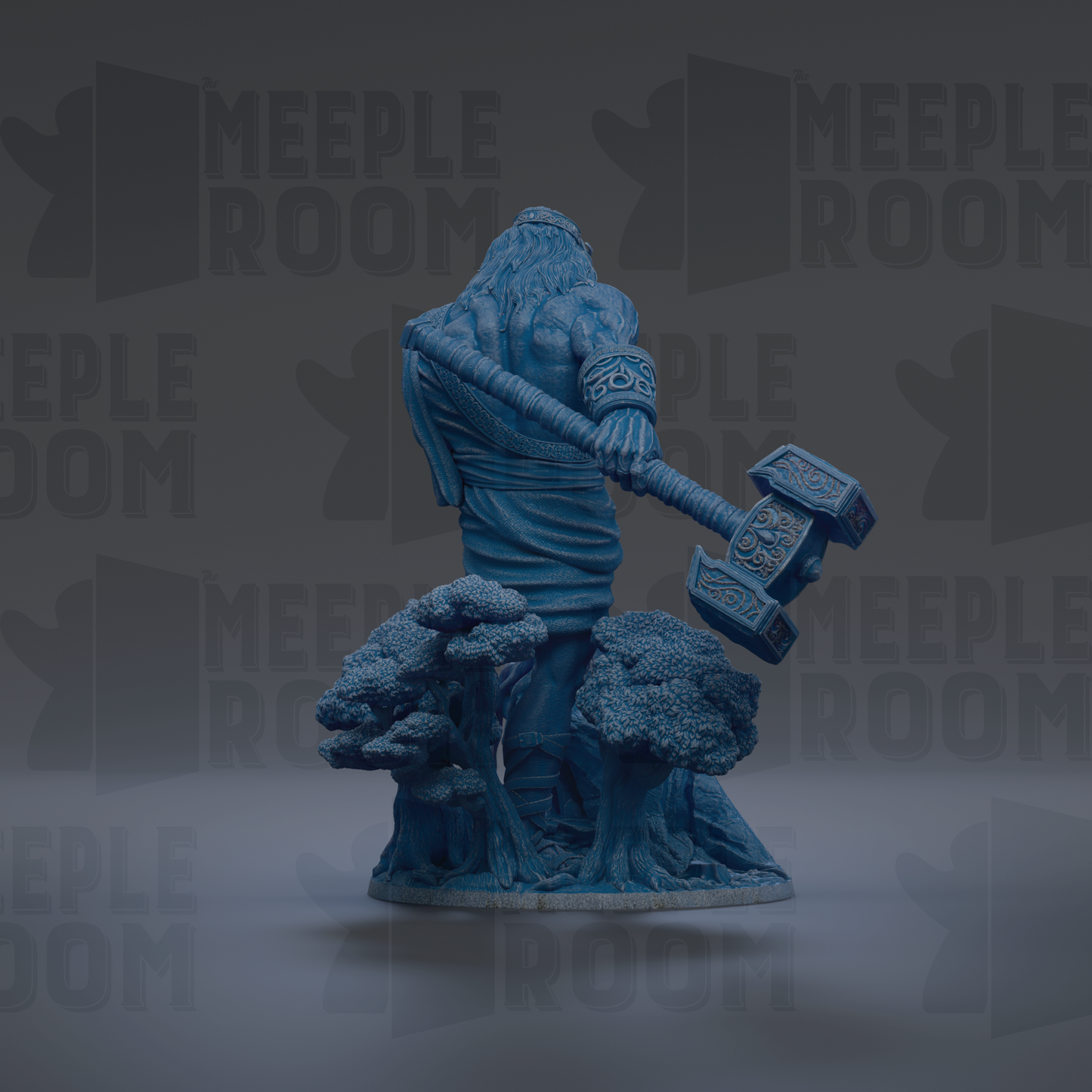 A blue statue of a muscular man holding a large hammer, standing on a rock formation with trees in the background.