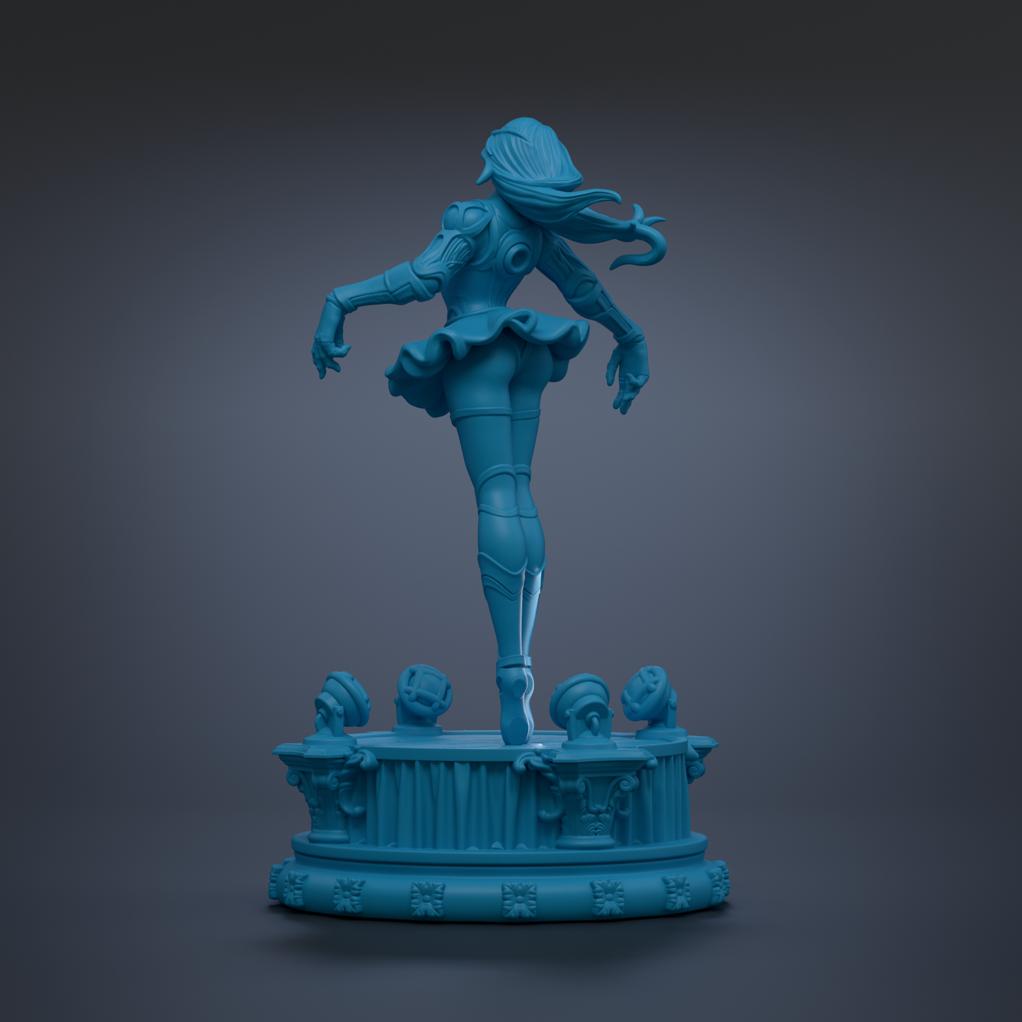 A blue statue of a female figure with flowing hair and a tutu, standing on a pedestal with other smaller statues on it.