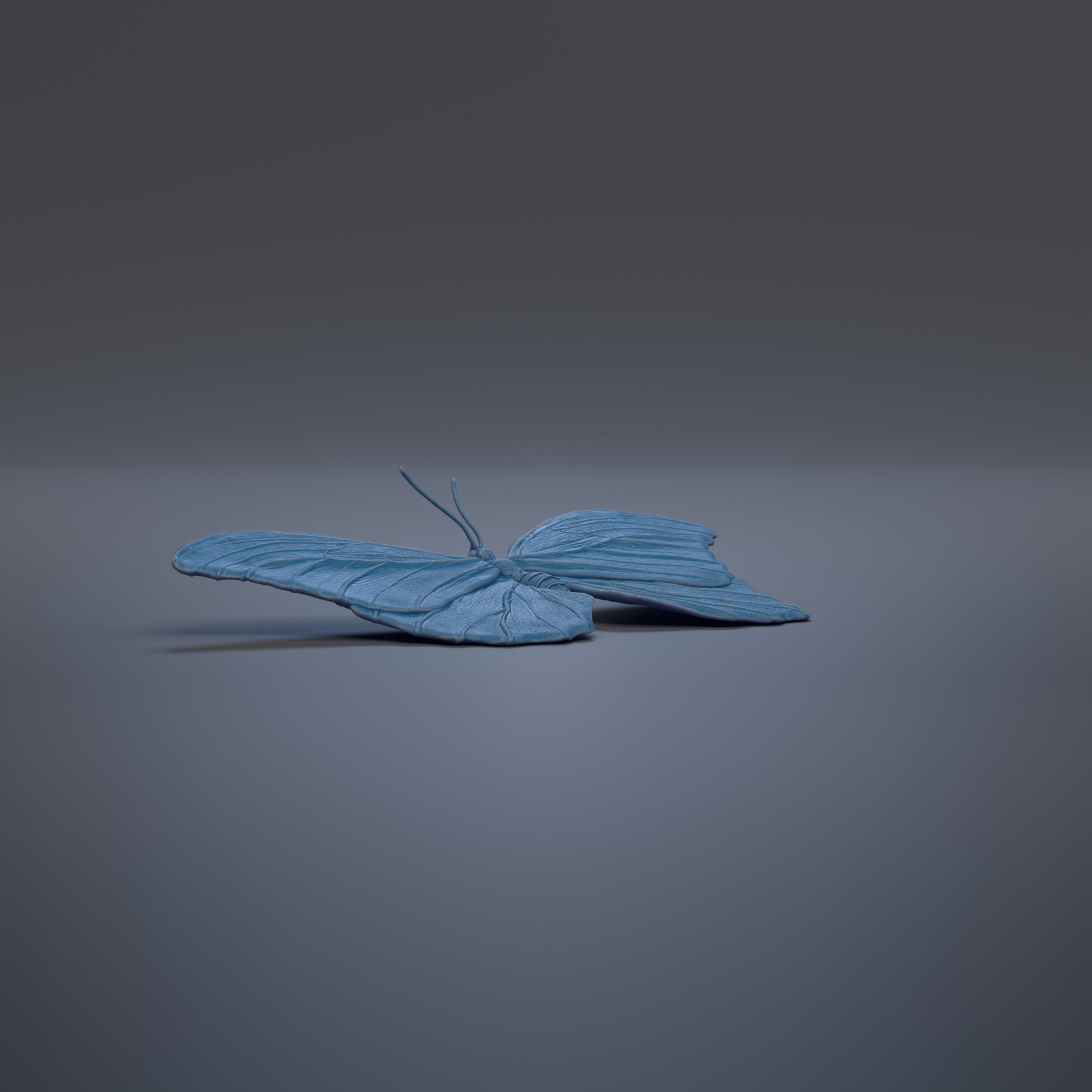 A blue butterfly sculpture is shown against a dark background.