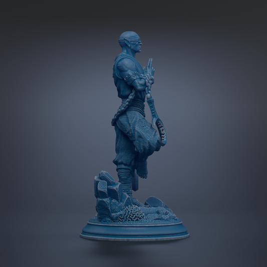 A blue statue of a person standing on a rock formation against a dark background.