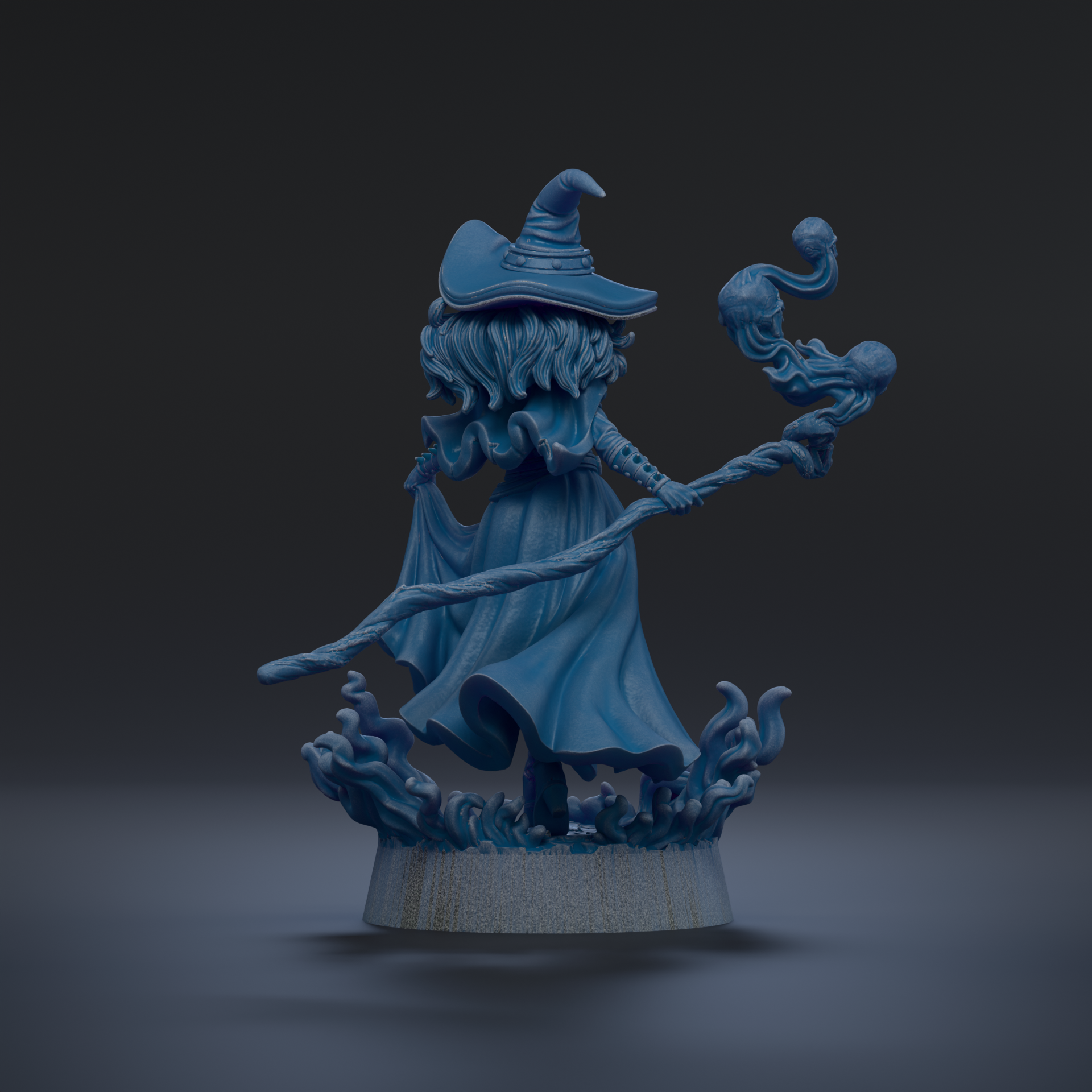 A blue, fantastical statue of a woman with long hair and a pointed hat, holding a staff and surrounded by swirling, ethereal elements.