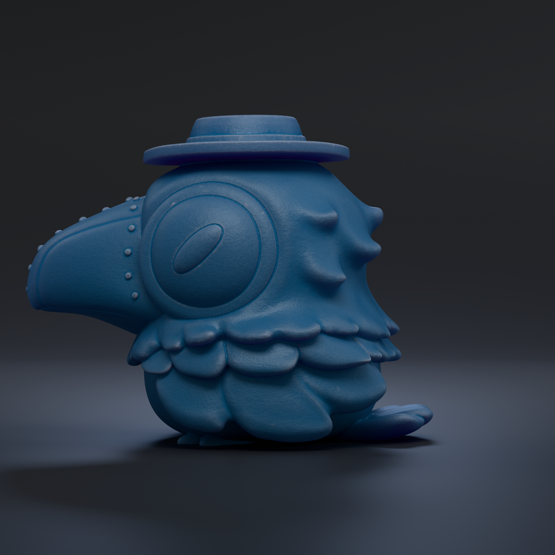 A blue, cartoonish bird figurine with a hat on its head, sitting on a dark surface.