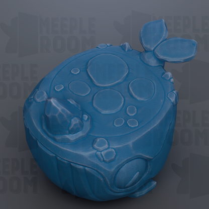 A blue, spherical object with a textured surface and circular shapes, resembling a toy or figurine.