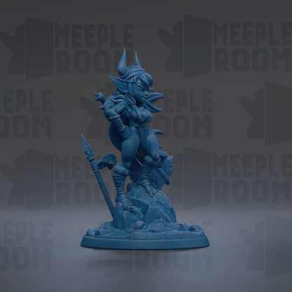 A blue figurine of a dragon-like creature with horns and a long tail, standing on a rock formation.