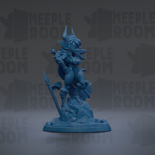 A blue figurine of a dragon-like creature with horns and a long tail, standing on a rock formation.