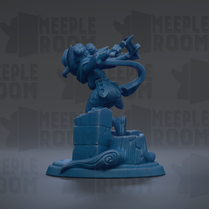 A blue figurine of a character with a sword and shield, standing on a pedestal.