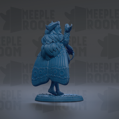 A blue figurine of a winged creature with a long tail, standing on a base and holding a small object in its hand.