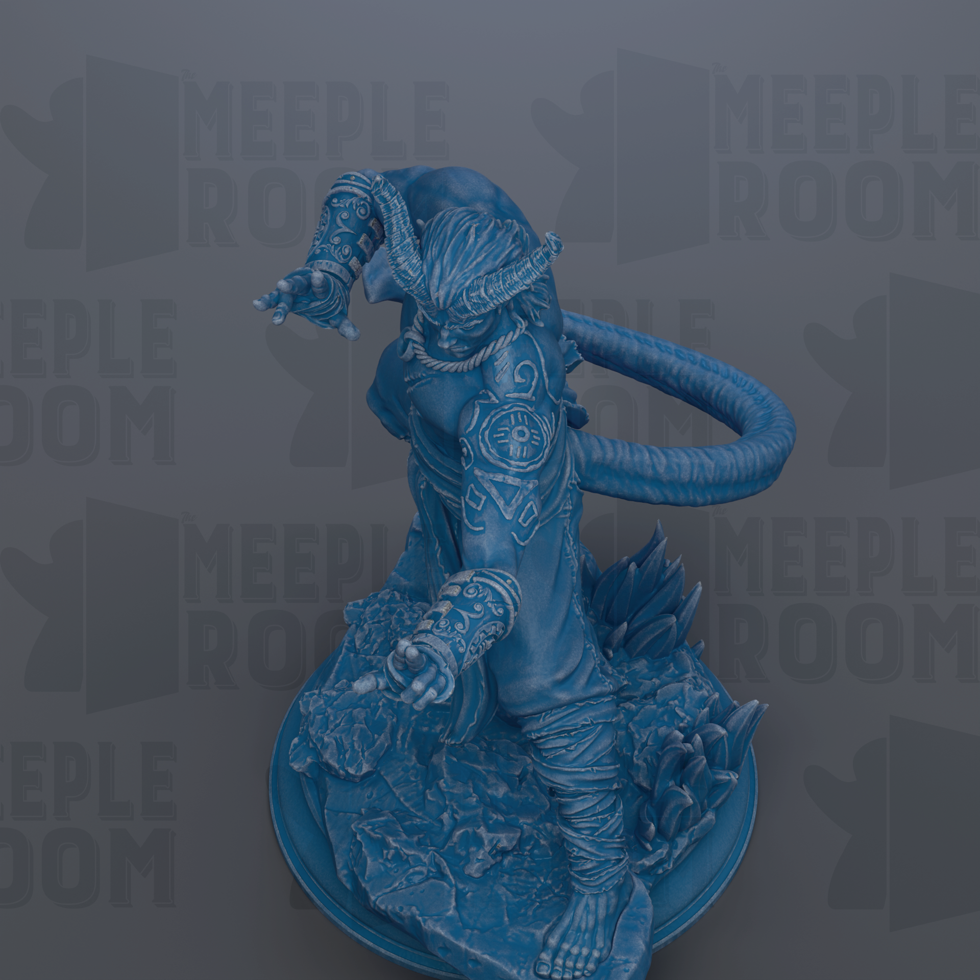 A blue figurine of a dragon-like creature with intricate patterns and designs, standing on a rock formation.