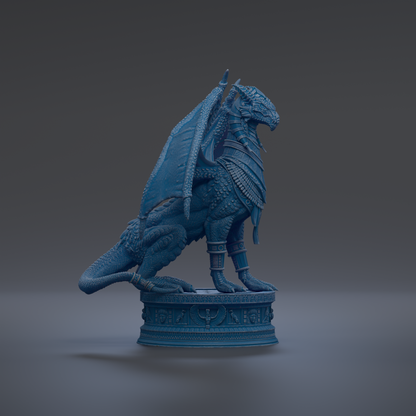 A blue dragon statue with wings and scales, standing on a pedestal with intricate designs.