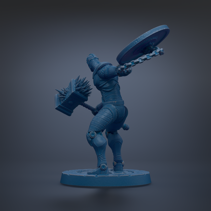 A blue, metallic statue of a warrior figure holding a shield and a club, standing on a circular base.