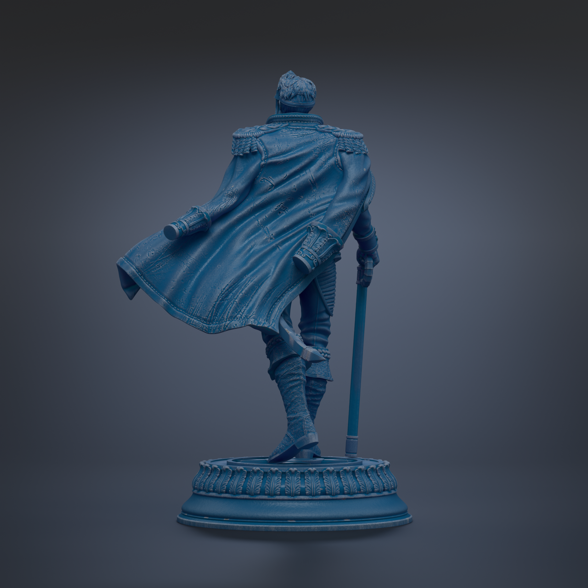 A statue of a person in a cape, standing on a pedestal.