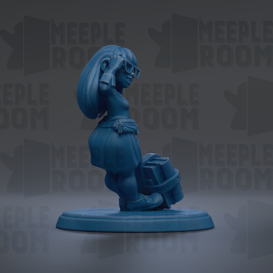 A blue figurine of a woman with long hair and glasses is standing on a blue base, holding a suitcase.