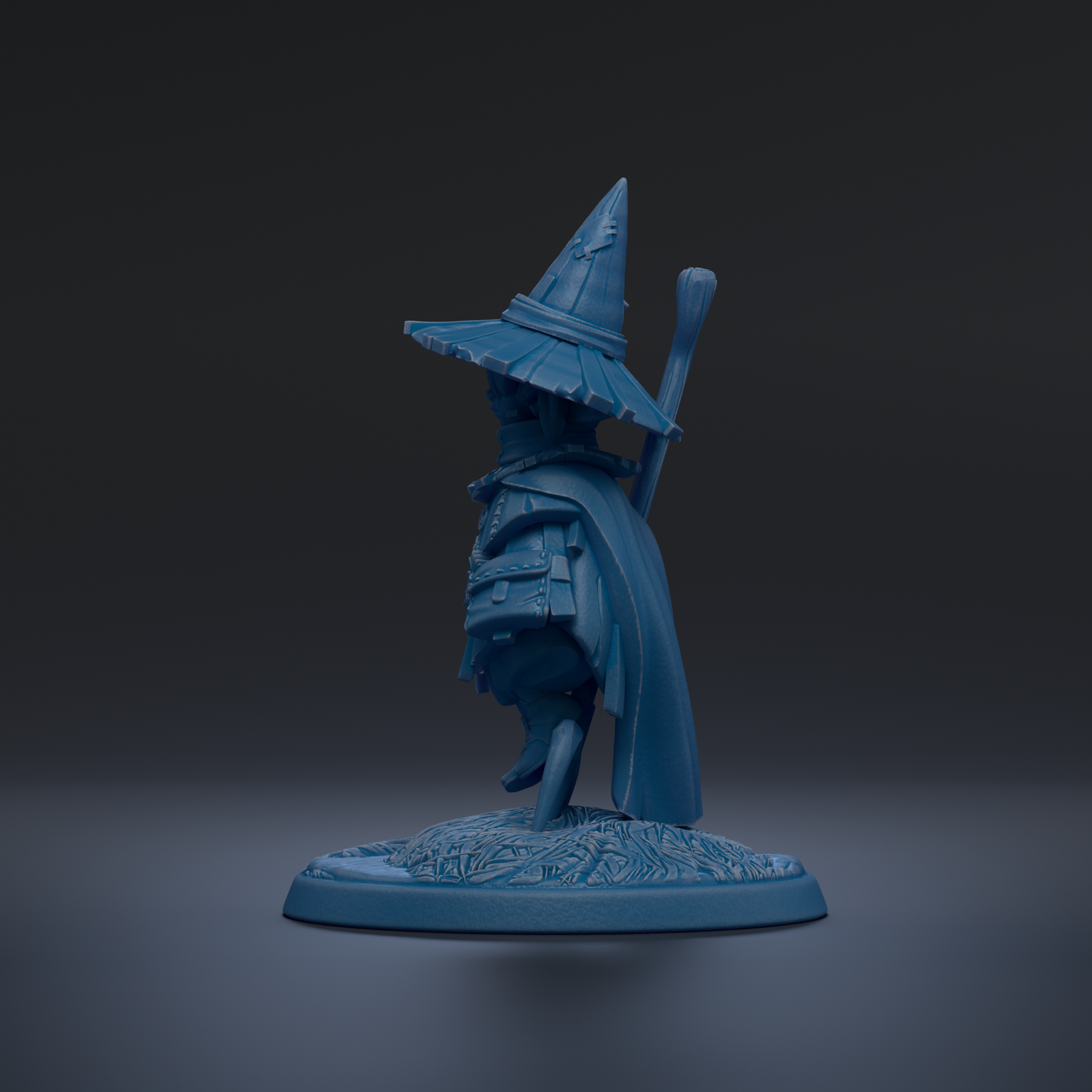 A blue figurine of a wizard or magical figure wearing a pointed hat and holding a staff, standing on a base with a floral design.