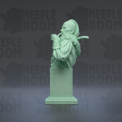 A green bust sculpture of a person with a beard and mustache, sitting on a pedestal.