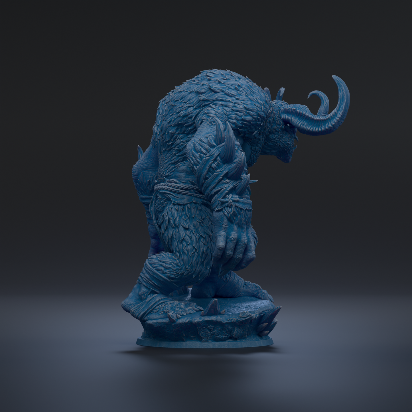 A blue, furry statue of a creature with horns and a fierce expression, standing on a rock.