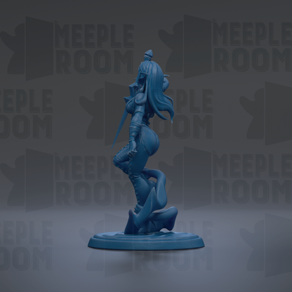 A blue figurine of a female character with long hair and a flowing skirt, standing on a base and holding a weapon.