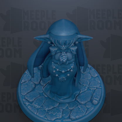 A blue figurine of a person with a pointed hat and a necklace, standing on a stone base.