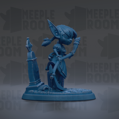 A blue figurine of a character with large ears and a pointed hat, standing on a base with a skull and crossbones symbol.