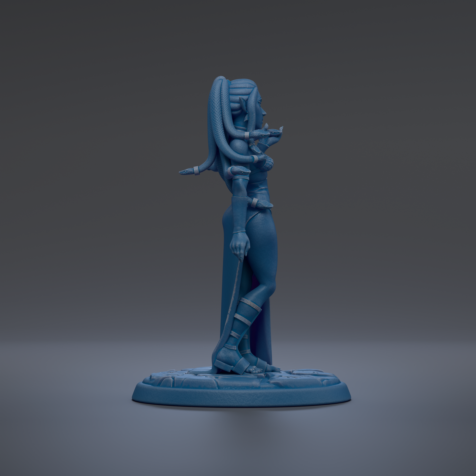 A blue figurine of a woman with long hair and a snake-like design on her back, standing on a base.