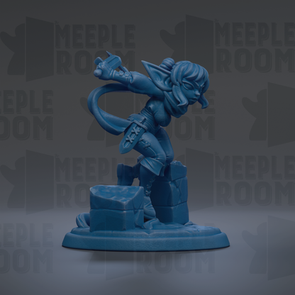 A blue figurine of a female character with a sword and shield, standing on a rock formation.