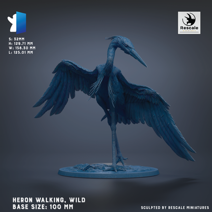 A large blue heron statue with outstretched wings, standing on a circular base.