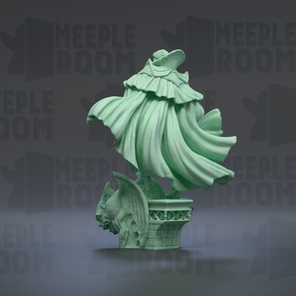 A green statue of a winged figure with a flowing robe, standing on a pedestal.