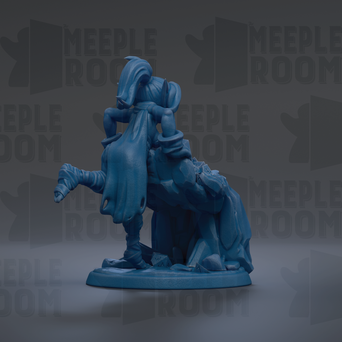 A blue figurine of a person with a long, flowing cape and a pointed hat, sitting on a rock formation.