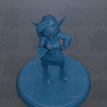 A blue figurine of a person standing on a blue platform, holding a book in their hand.