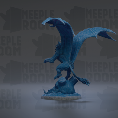 A blue dragon figurine with wings spread, standing on a rock.