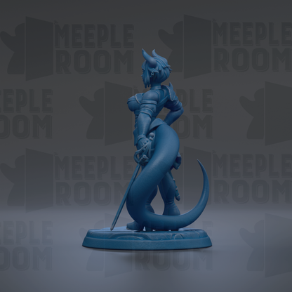 A blue figurine of a dragon-like creature with horns and a sword, standing on a base and holding a shield.