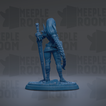 A blue figurine of a female character with long hair and a sword, standing on a base.