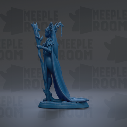 A blue figurine of a winged, winged creature with a long tail, standing on a base and holding a staff.