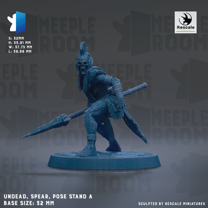 a figurine of a warrior standing on a base, holding a spear and a shield. The figurine is in a crouching position, ready for battle. The figurine is made of a dark material, possibly metal or stone, and is displayed on a blue base. The figurine is described as "UNDEAD, SPEAR, POSE STAND A BASE SIZE: 32MM".