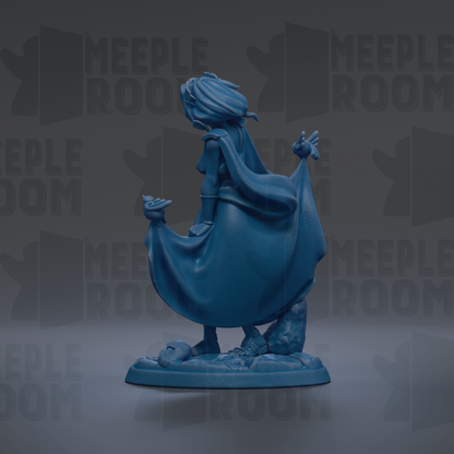 A blue figurine of a woman with flowing hair and a flowing cape, standing on a base with a rock formation.