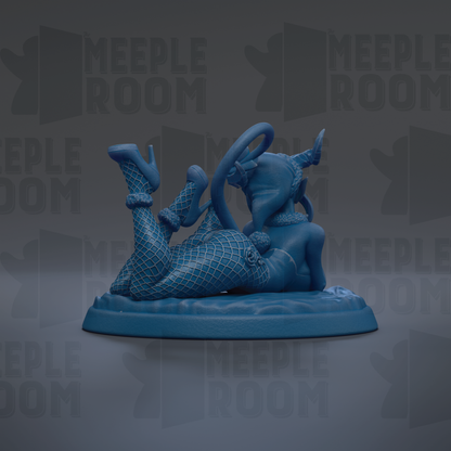 A blue figurine of a woman with fishnet stockings and high heels, lying on a blue base.